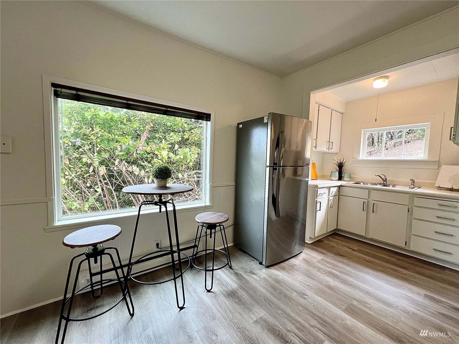 432 Cedar Avenue South Renton, WA 98057 - Photo 24 of 38 a kitchen with a refrigerator a sink and white cabinets