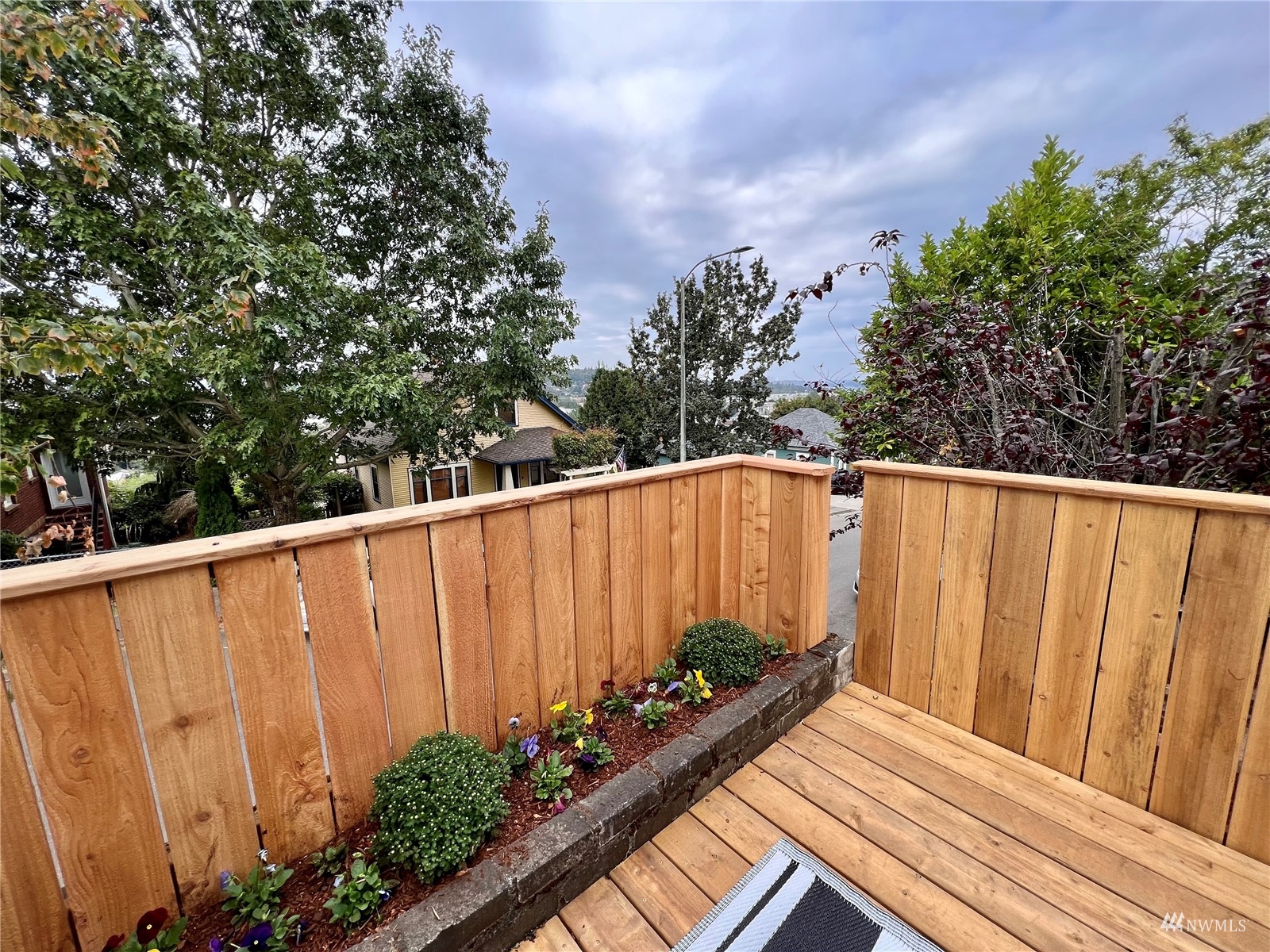 432 Cedar Avenue South Renton, WA 98057 - Photo 7 of 38 a view of a backyard with potted plants and wooden fence