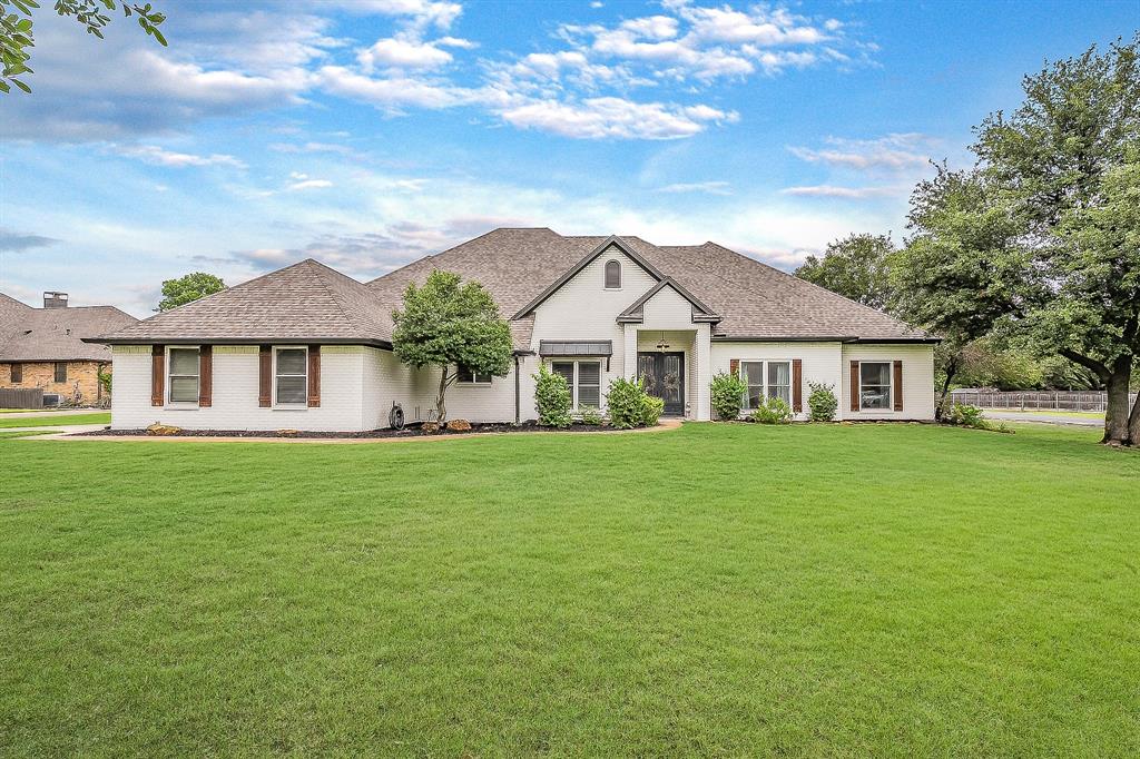 115 Pheasant Run Road Argyle, TX 76226 - Photo 38 of 40 a front view of a house with a garden