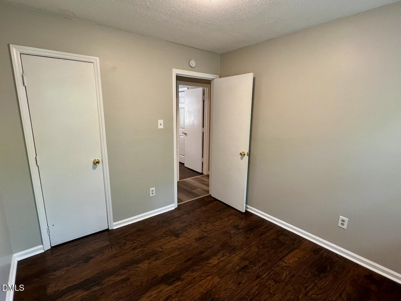 1320 Poole Road, Unit L Raleigh, NC 27610 - Photo 11 of 12 a view of an empty room with wooden floor