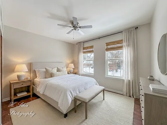 a bedroom with a large bed and a chandelier