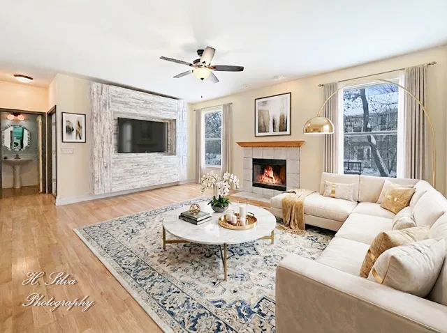 a living room with furniture a fireplace and a flat screen tv