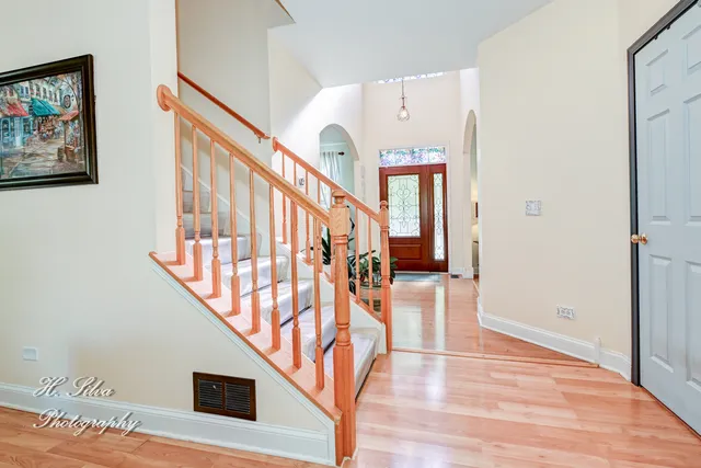 a view of entryway and hall with wooden floor