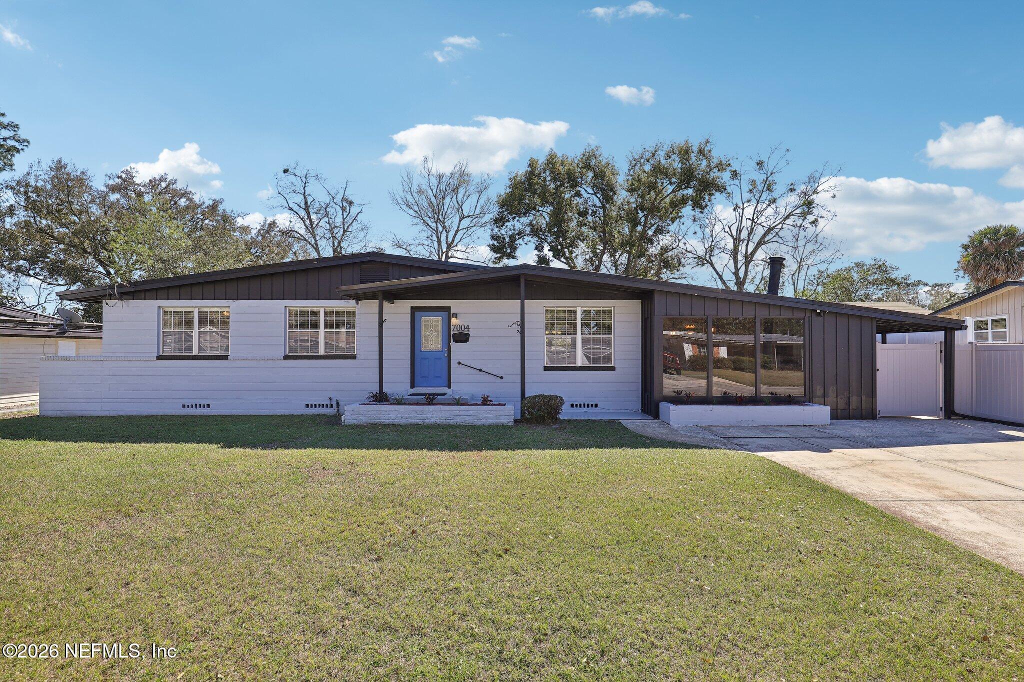 7004 Waikiki Road Jacksonville, FL 32216 - Photo 1 of 41 a front view of a house with a yard and garage