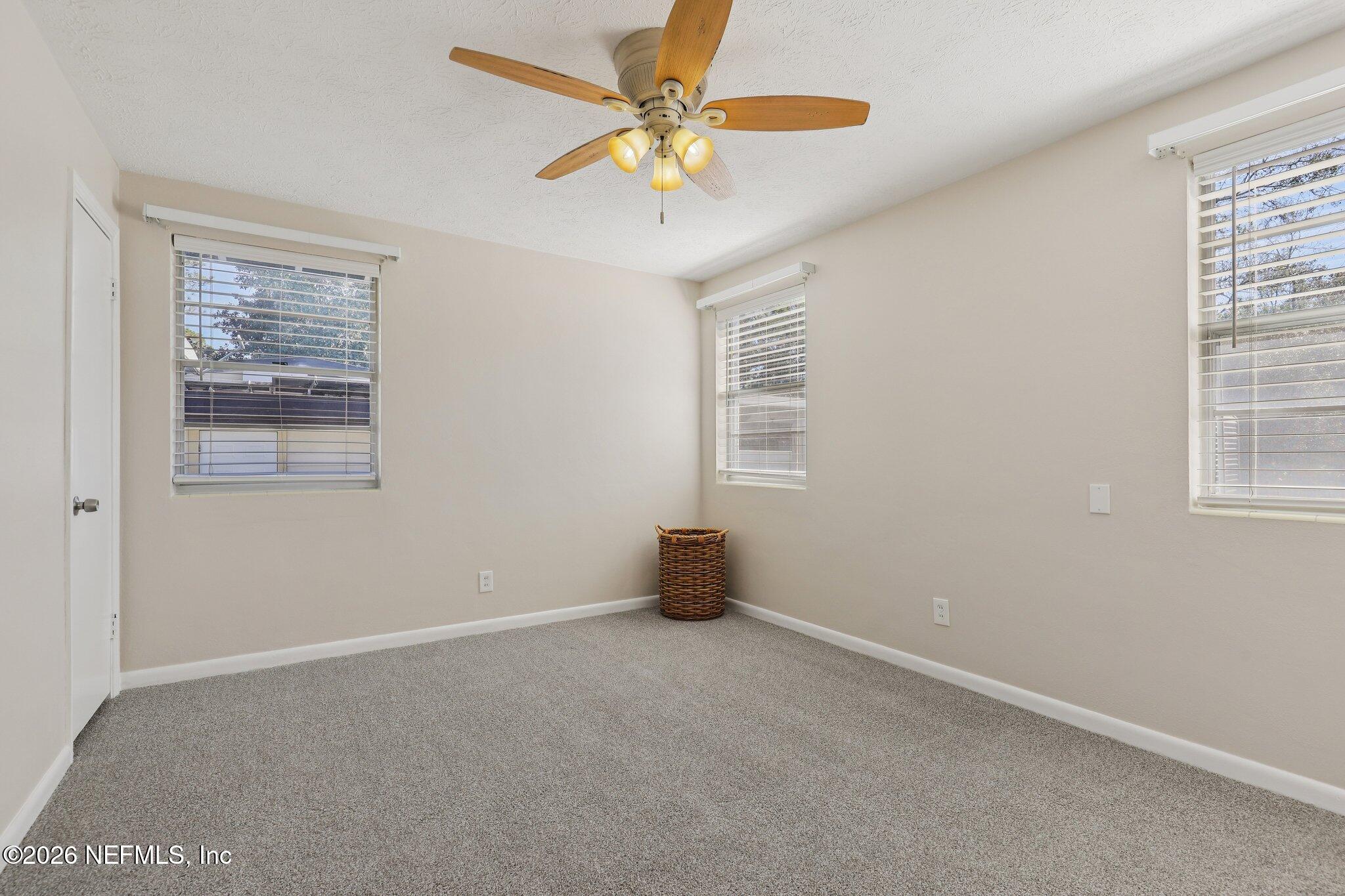 7004 Waikiki Road Jacksonville, FL 32216 - Photo 12 of 41 an empty room with windows and fan