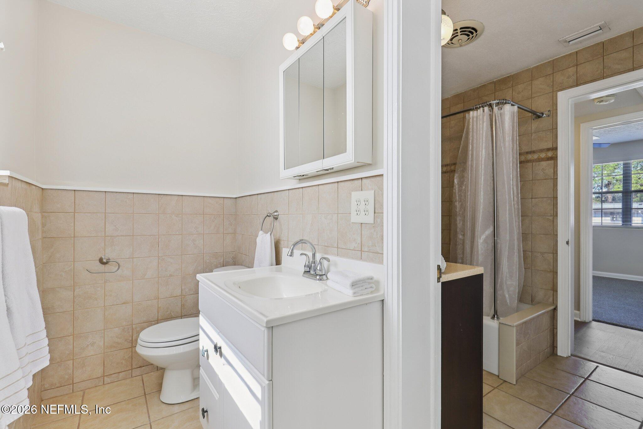 7004 Waikiki Road Jacksonville, FL 32216 - Photo 13 of 41 a bathroom with a sink a toilet and shower