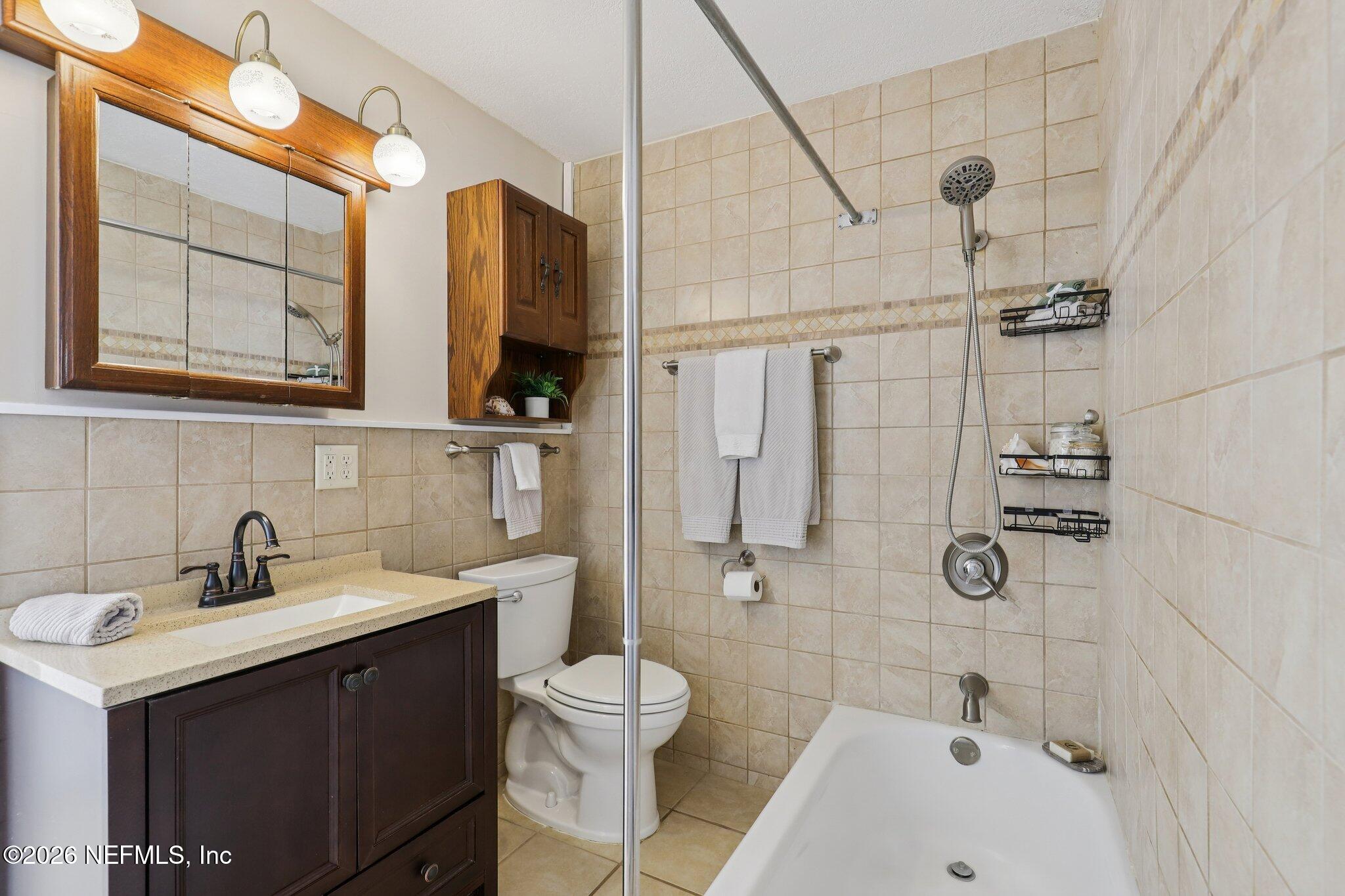 7004 Waikiki Road Jacksonville, FL 32216 - Photo 16 of 41 a bathroom with a sink a toilet and shower