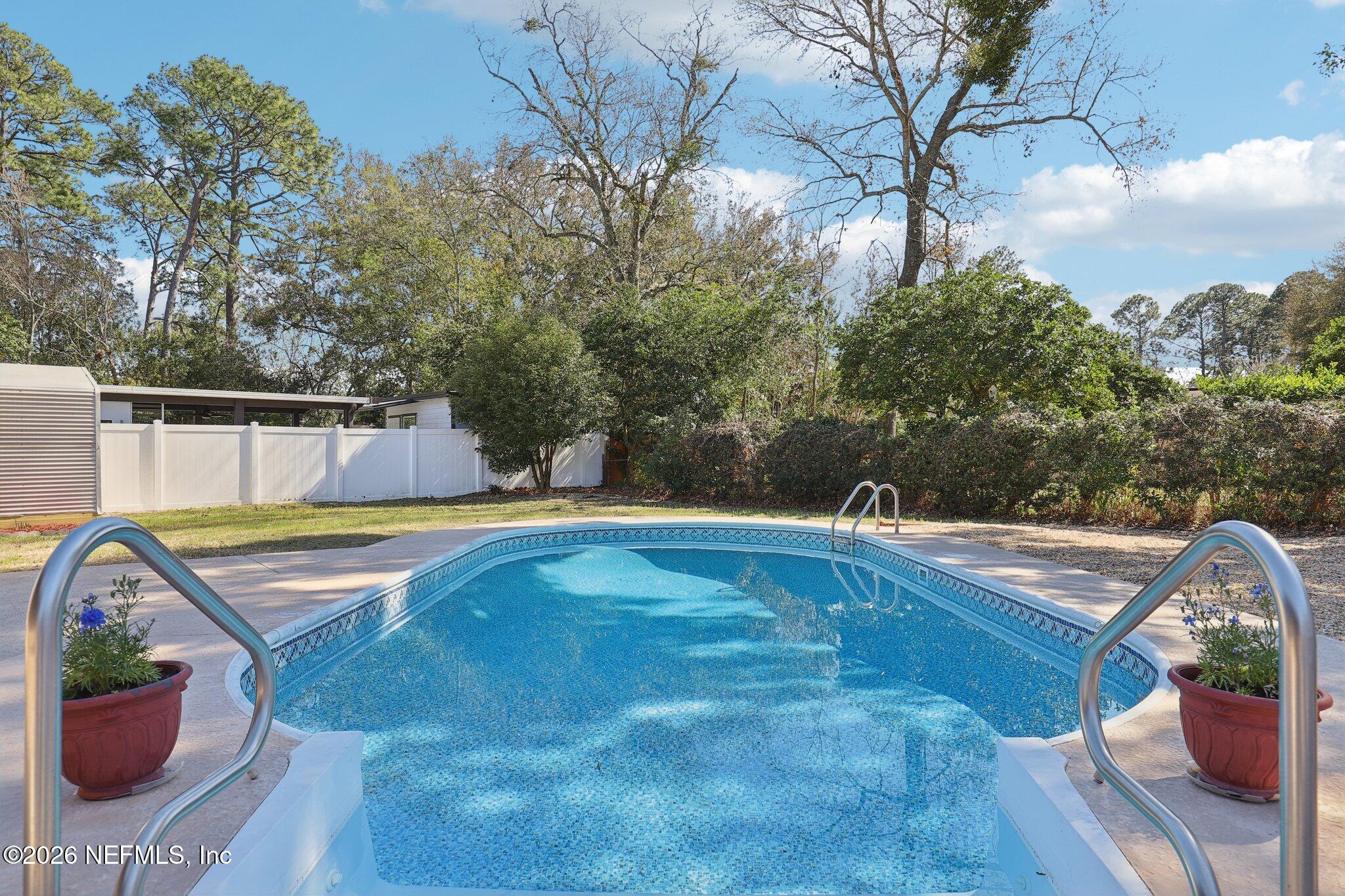 7004 Waikiki Road Jacksonville, FL 32216 - Photo 19 of 41 a view of a swimming pool with a patio