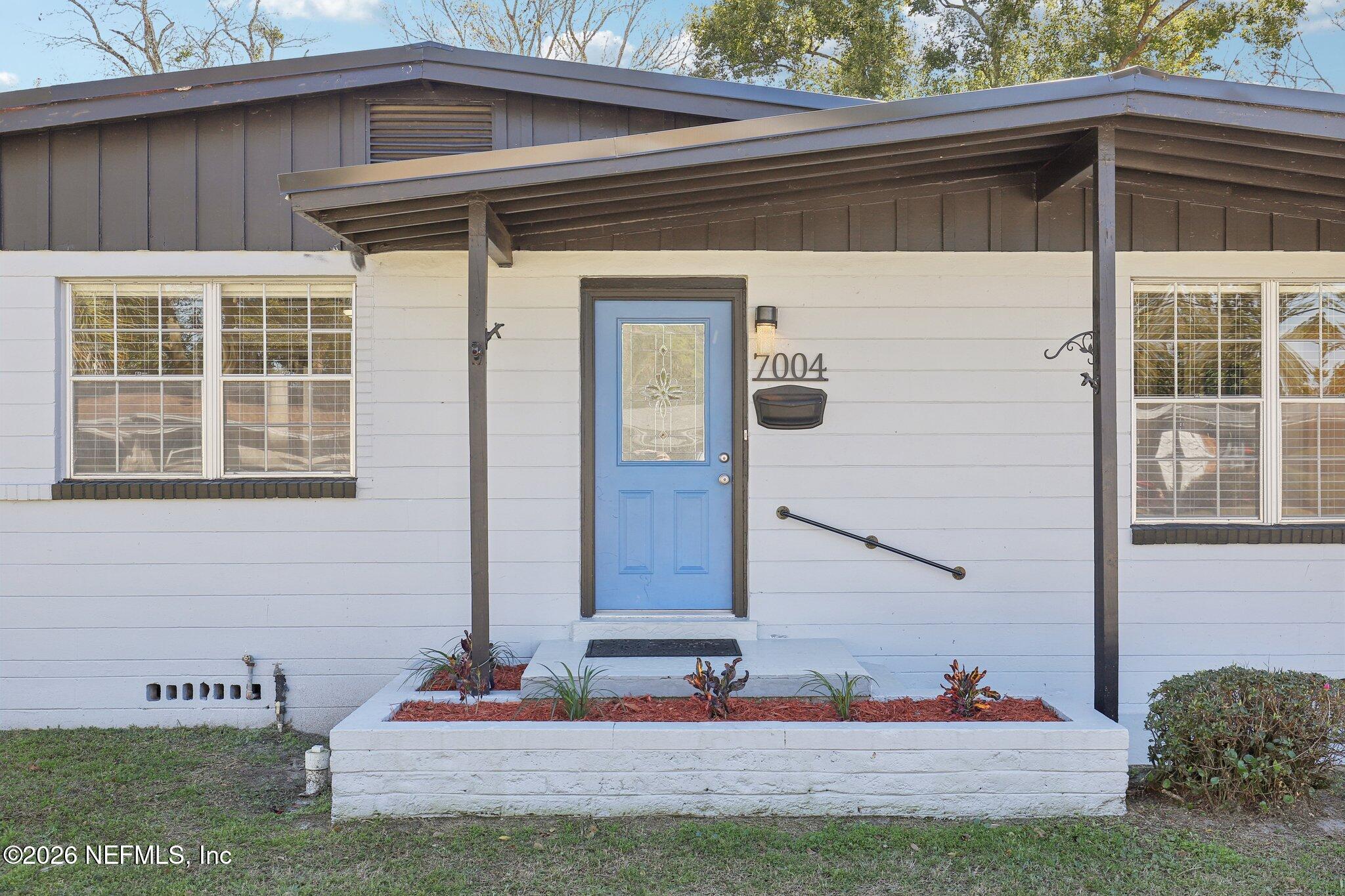 7004 Waikiki Road Jacksonville, FL 32216 - Photo 2 of 41 a front view of a house with a yard