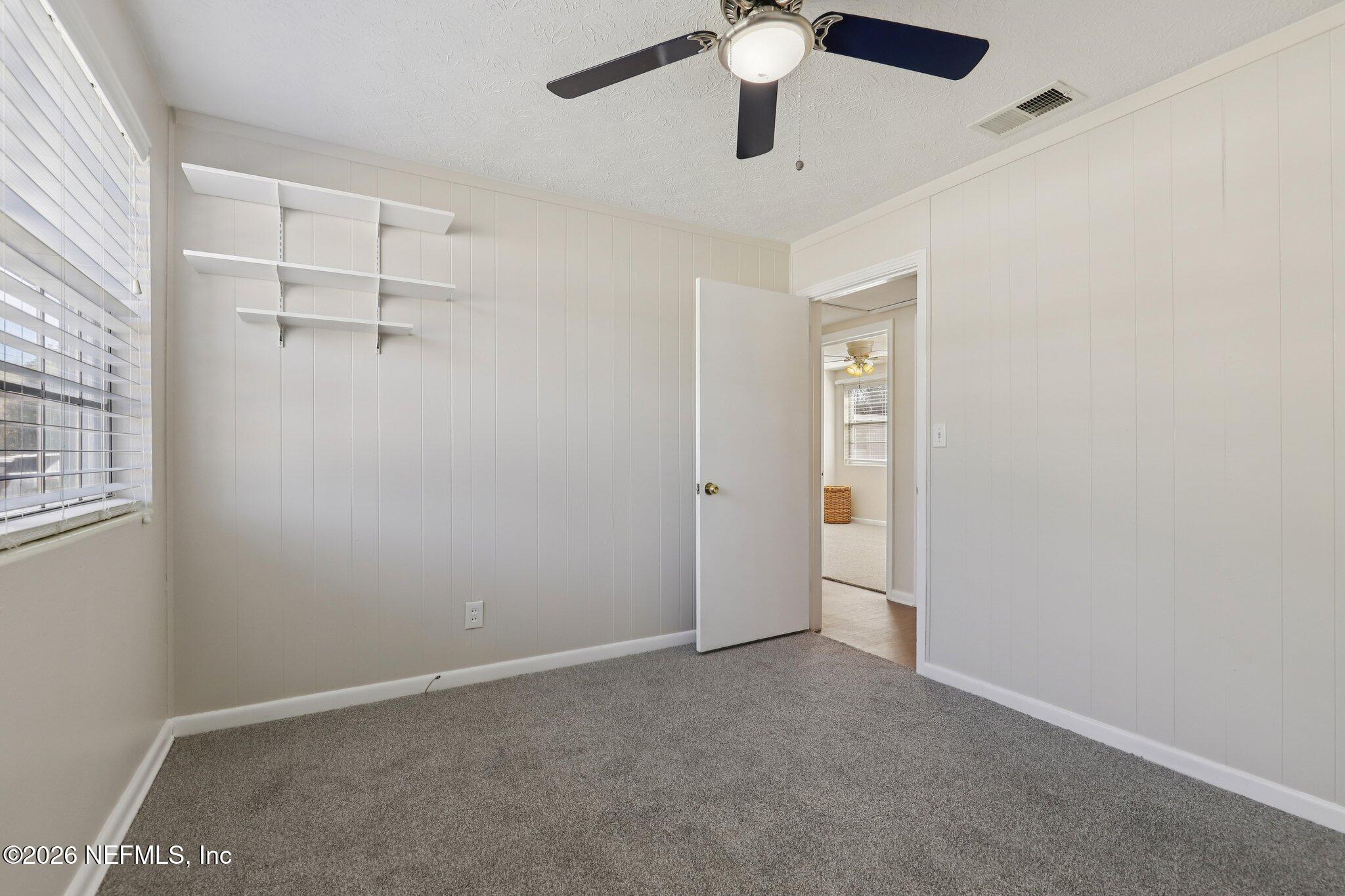 7004 Waikiki Road Jacksonville, FL 32216 - Photo 30 of 41 an empty room with windows and fan
