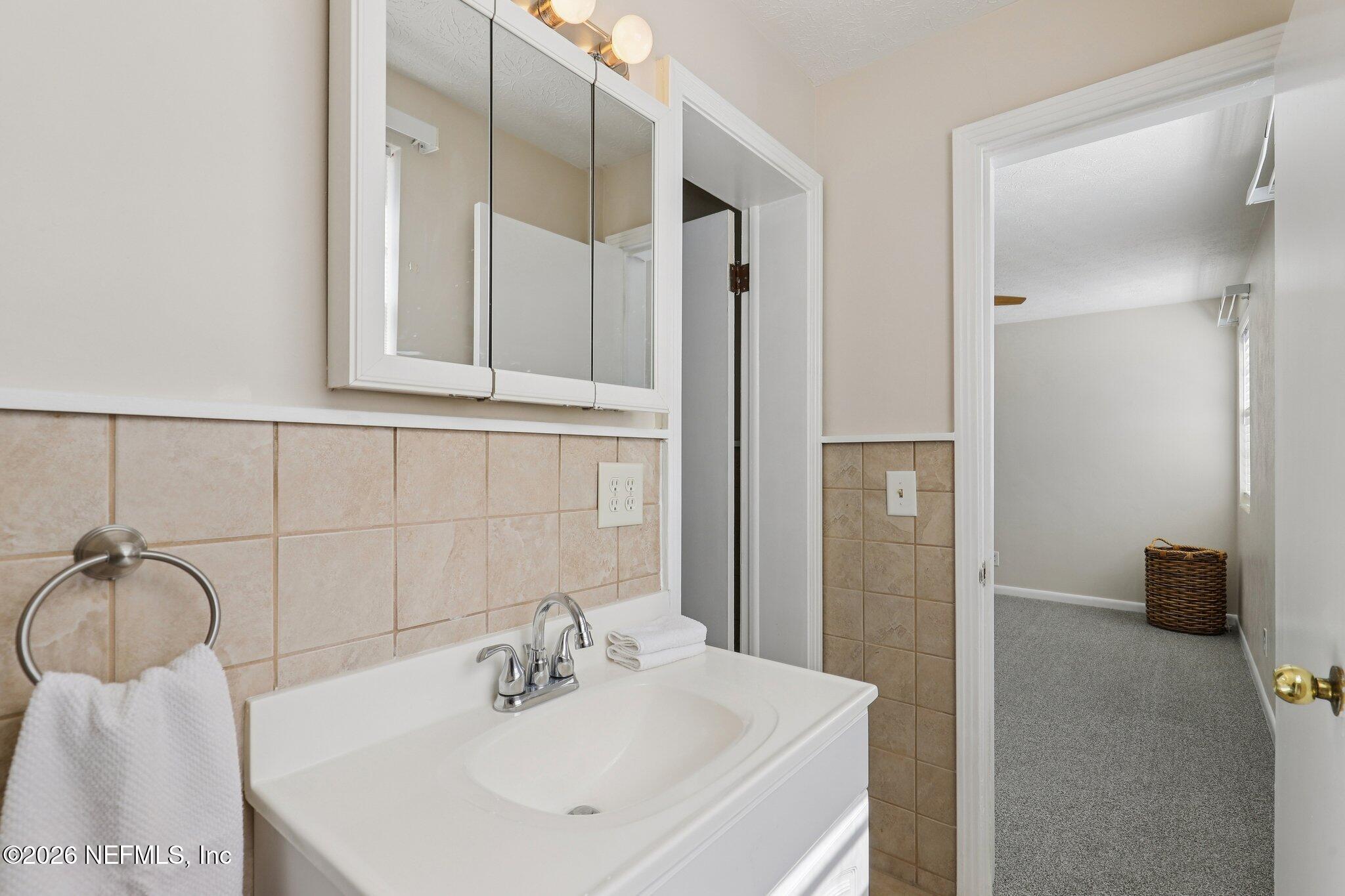 7004 Waikiki Road Jacksonville, FL 32216 - Photo 34 of 41 a bathroom with a sink and a mirror