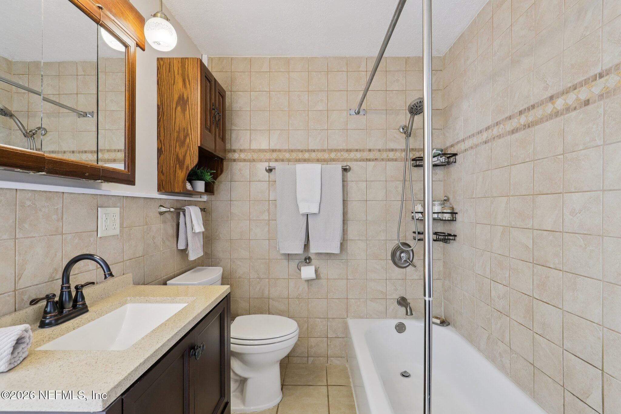 7004 Waikiki Road Jacksonville, FL 32216 - Photo 35 of 41 a bathroom with a sink toilet and shower