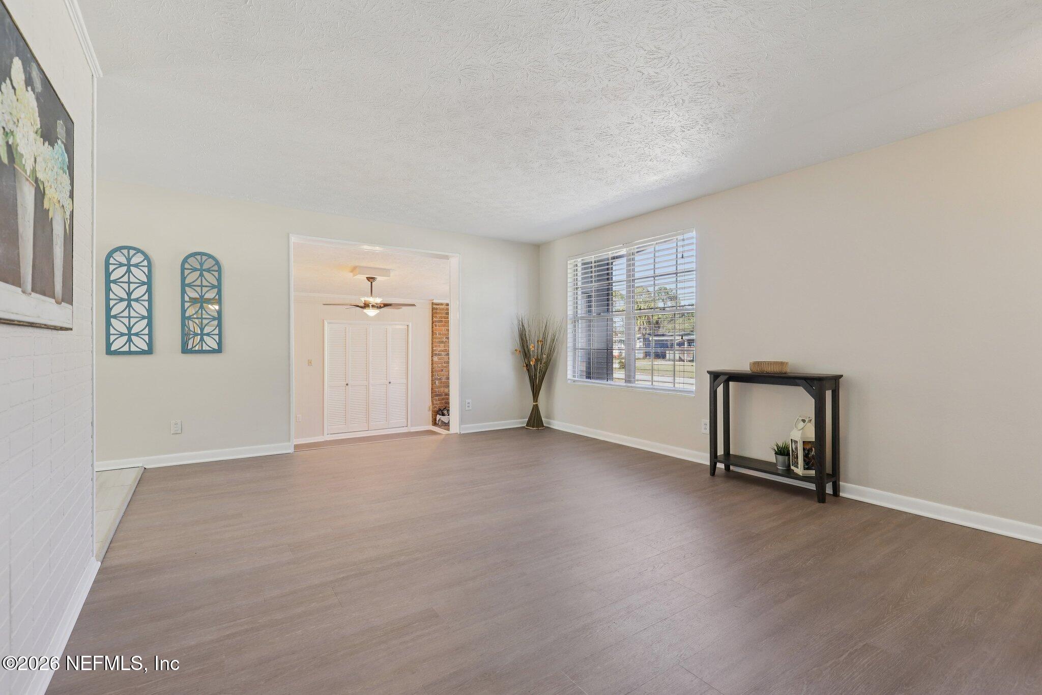 7004 Waikiki Road Jacksonville, FL 32216 - Photo 5 of 41 an empty room with windows and closet