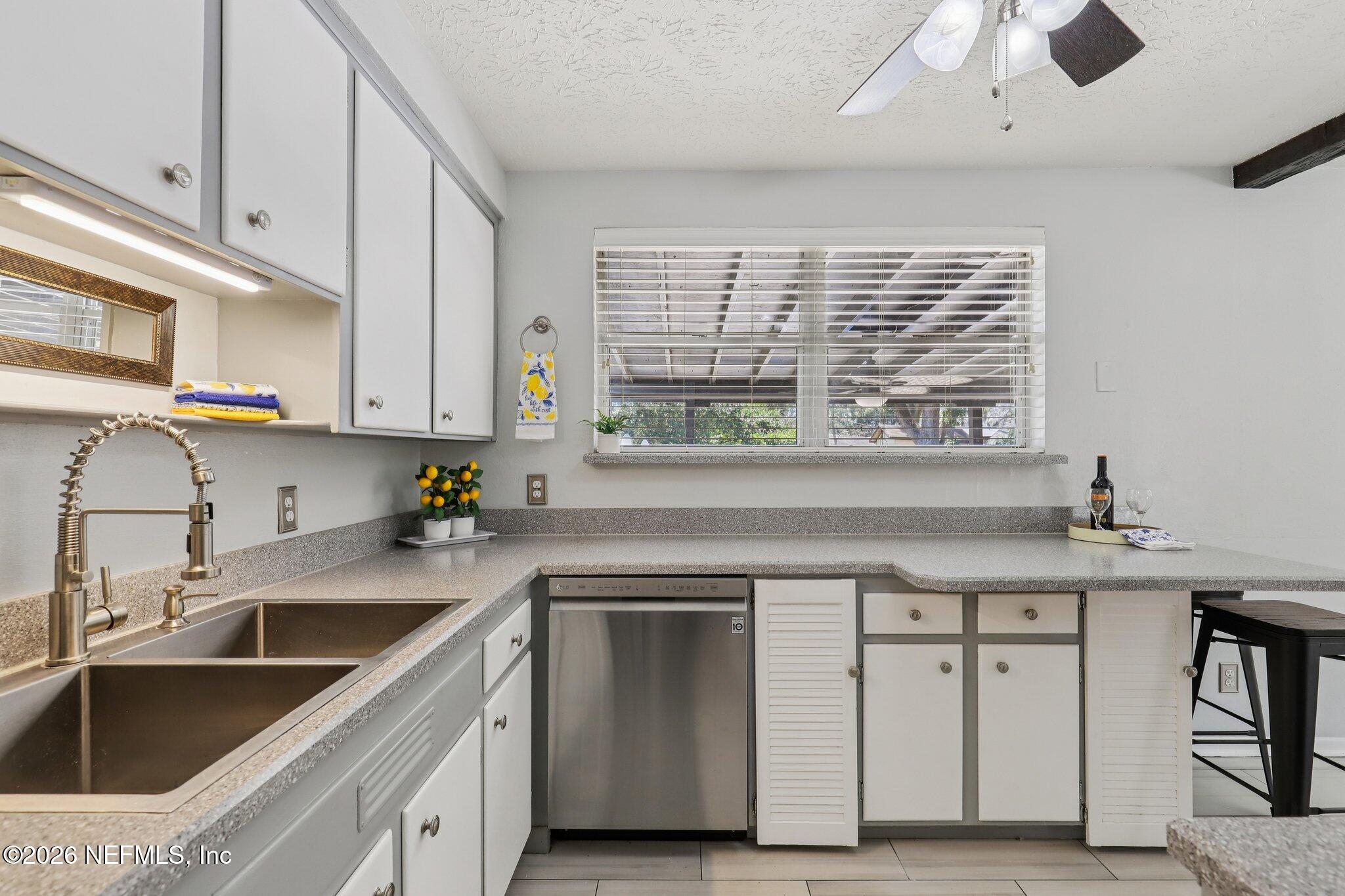 7004 Waikiki Road Jacksonville, FL 32216 - Photo 9 of 41 a kitchen with a sink cabinets and window