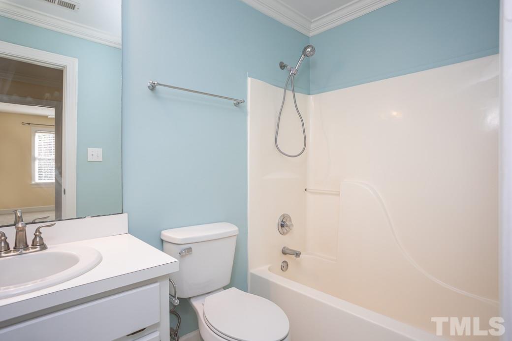 2409 Dahlgreen Road Raleigh, NC 27615 - Photo 22 of 30 a white toilet sitting next to a bathroom sink