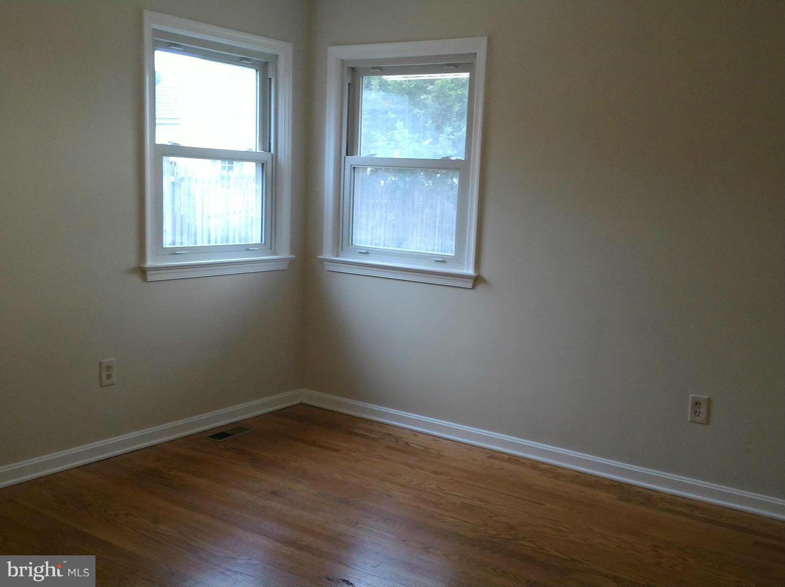16512 Walnut Hill Road Gaithersburg, MD 20877 - Photo 15 of 20 a view of an empty room with wooden floor and a window