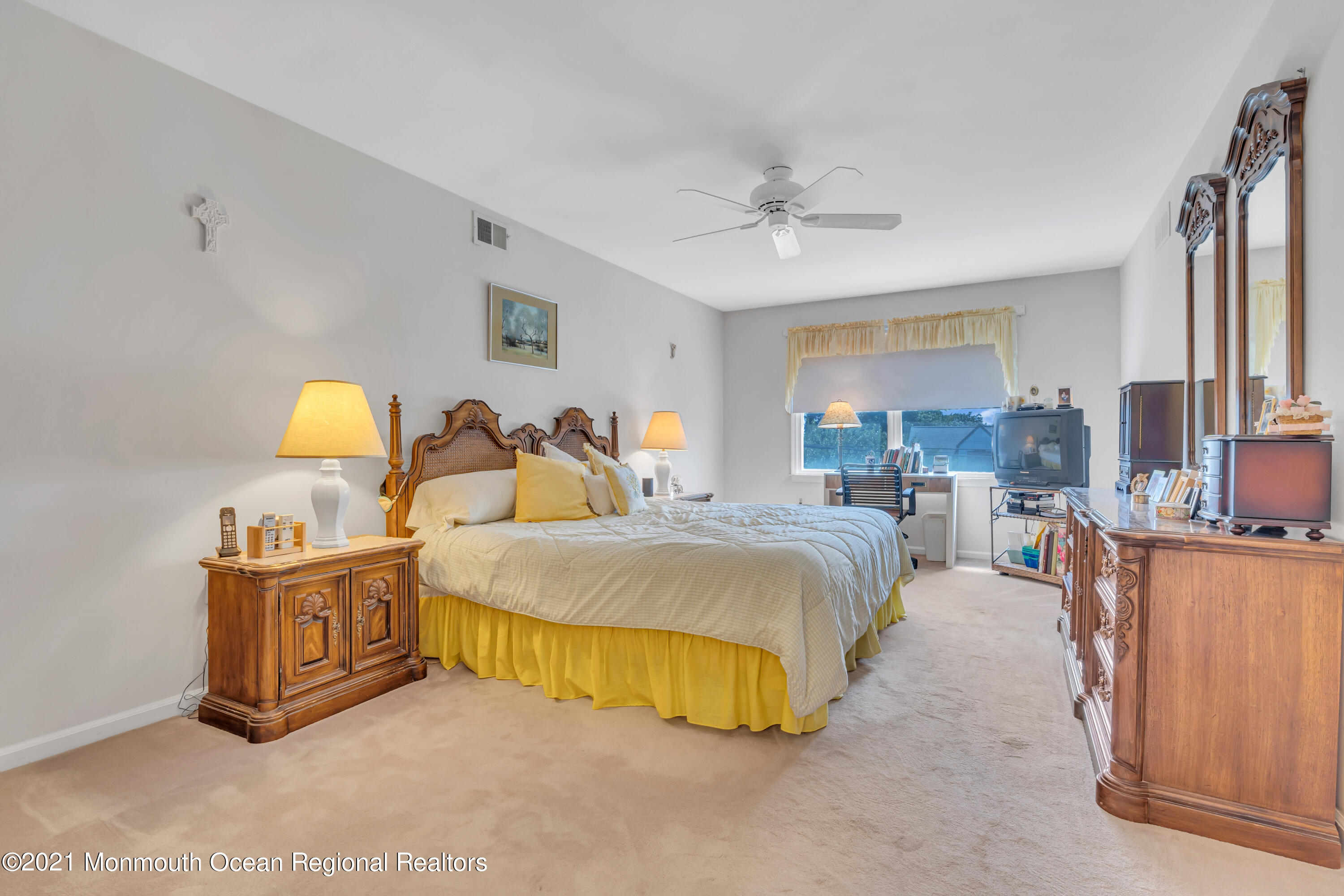 2221 Old Mill Road Spring Lake Heights, NJ 07762 - Photo 23 of 50 a spacious bedroom with a bed and a chandelier
