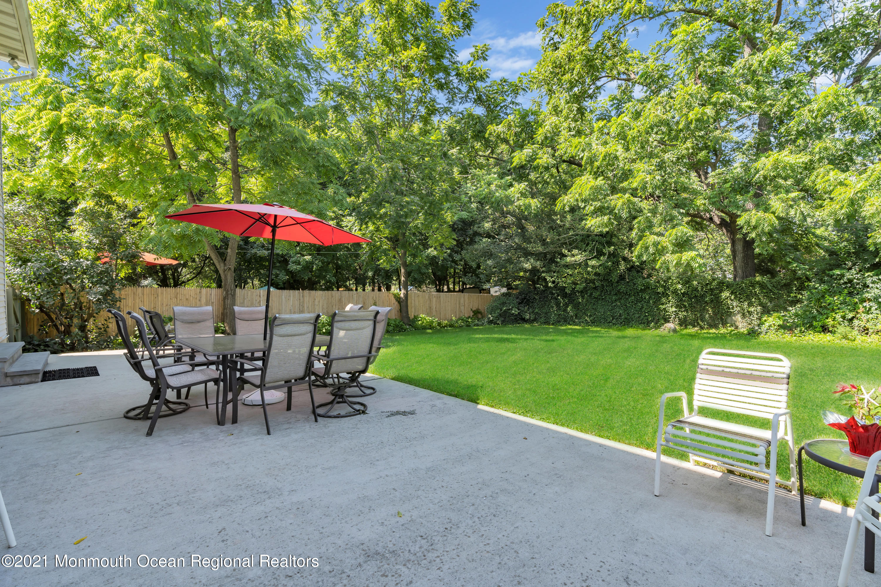 2221 Old Mill Road Spring Lake Heights, NJ 07762 - Photo 34 of 50 a view of a patio with a table and chairs under an umbrella