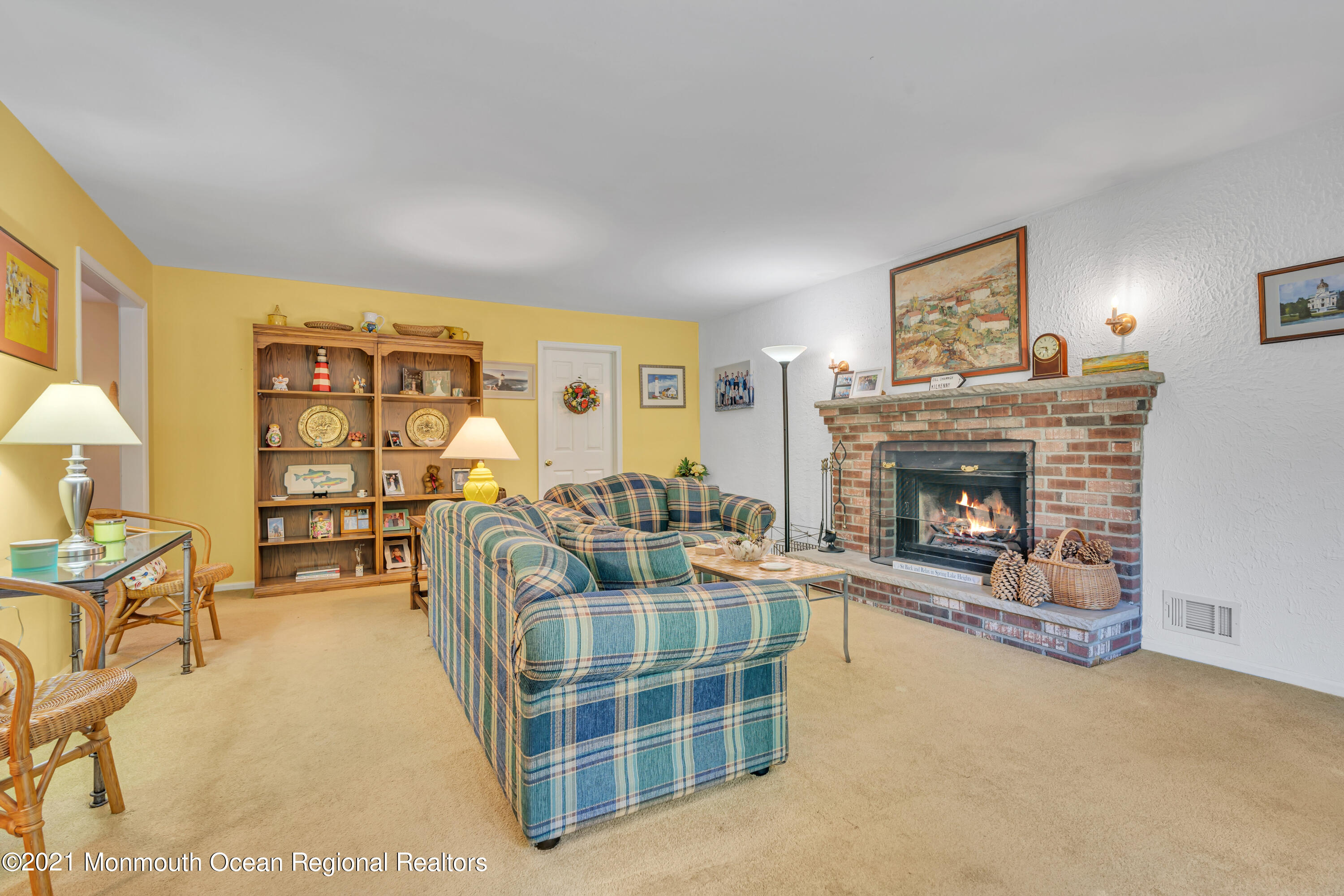 2221 Old Mill Road Spring Lake Heights, NJ 07762 - Photo 7 of 50 a living room with furniture a fireplace and a large window