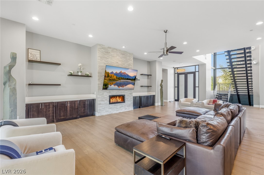 5 Crystal Tree Pass Henderson, NV 89052 - Photo 4 of 67 An inviting family room offers a grand fireplace, soaring ceilings, and abundant natural light.