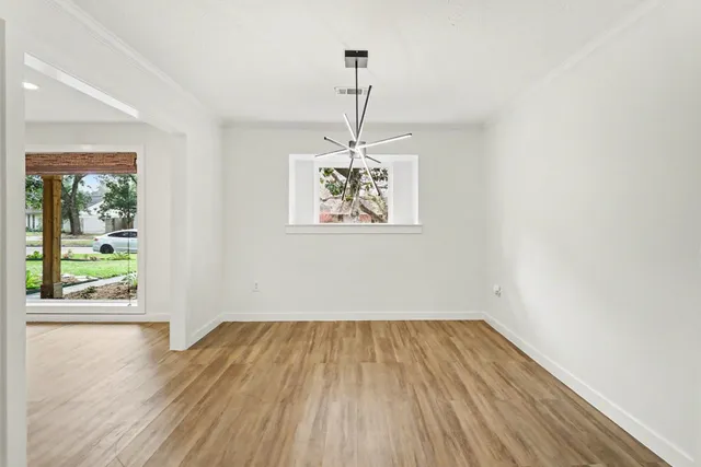 a view of room with window and wooden floor