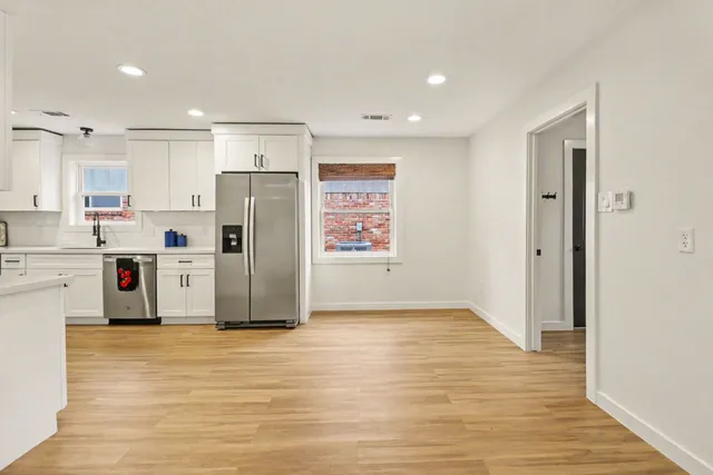 a kitchen with stainless steel appliances a refrigerator sink and cabinets