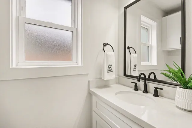 a bathroom with a sink and a mirror