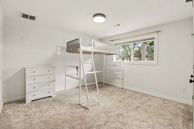 a view of room with window and cabinet