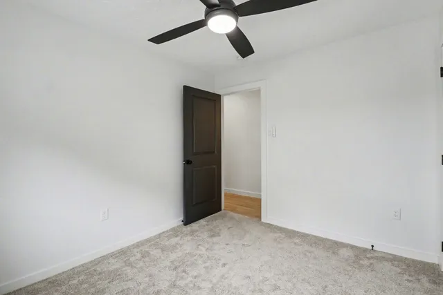 an empty room with a ceiling fan and a ceiling fan
