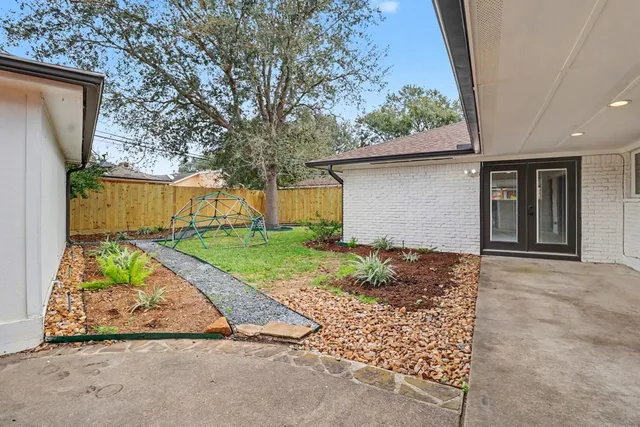 a view of backyard of house with green space
