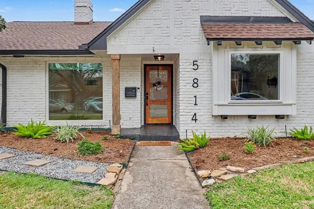 a front view of a house with garden