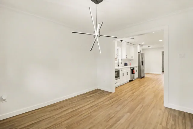 a view of a kitchen with wooden floor and a sink