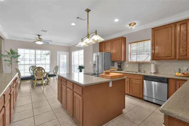 a kitchen with sink cabinets and dining table view