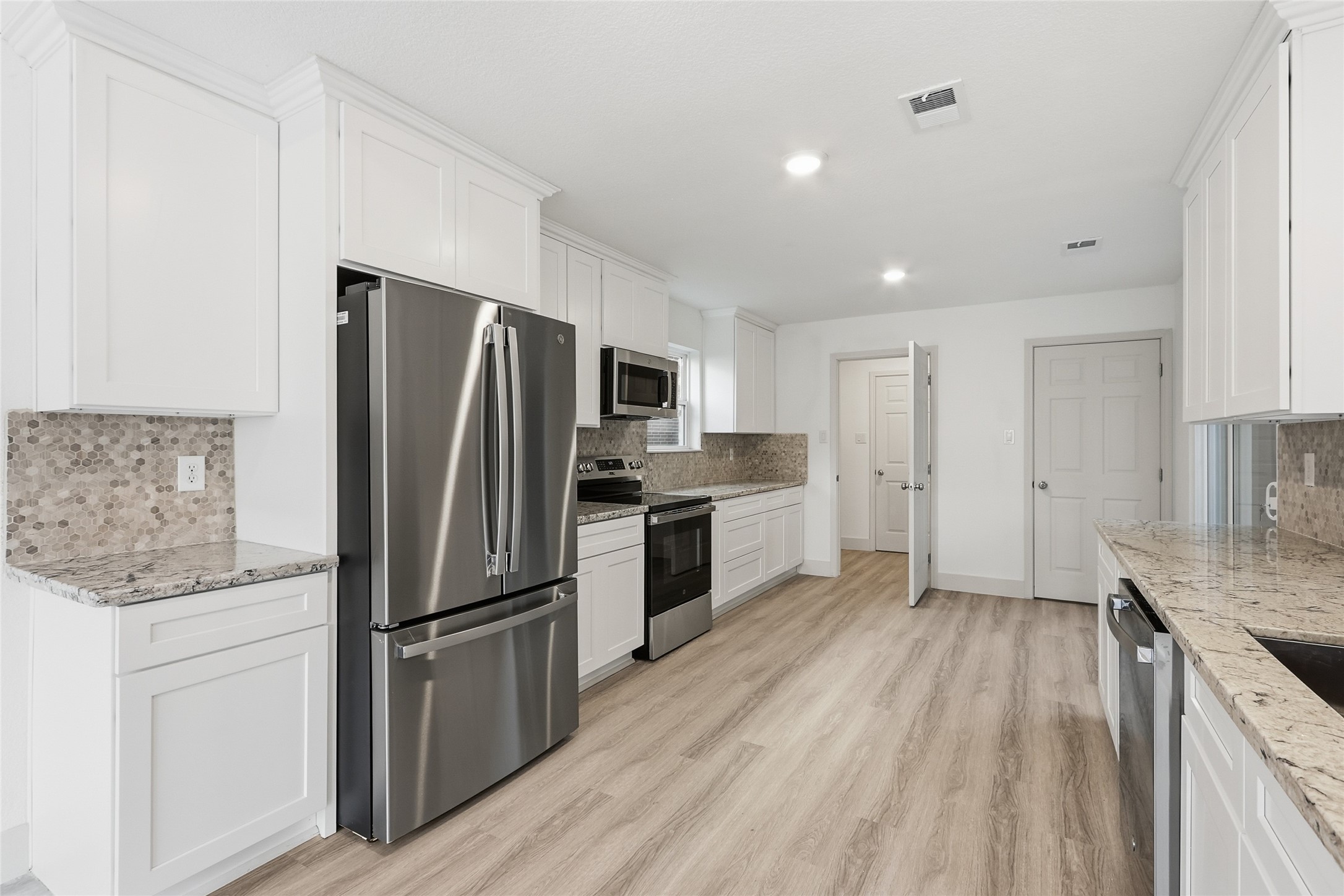19110 Baton Pass Humble, TX 77346 - Photo 12 of 41 a kitchen with a refrigerator a sink and dishwasher