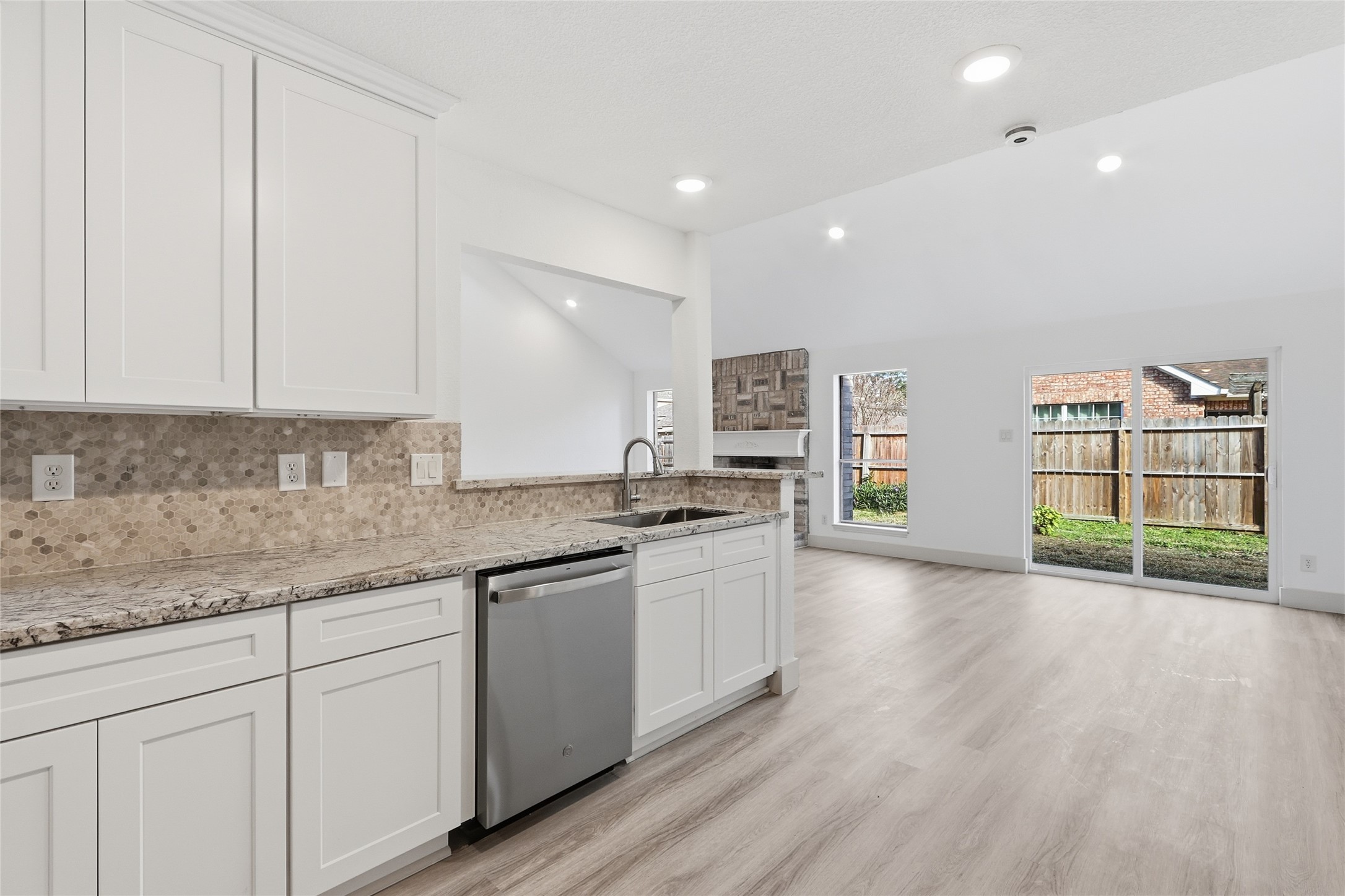 19110 Baton Pass Humble, TX 77346 - Photo 16 of 41 a kitchen with stainless steel appliances granite countertop a sink and cabinets with wooden floor