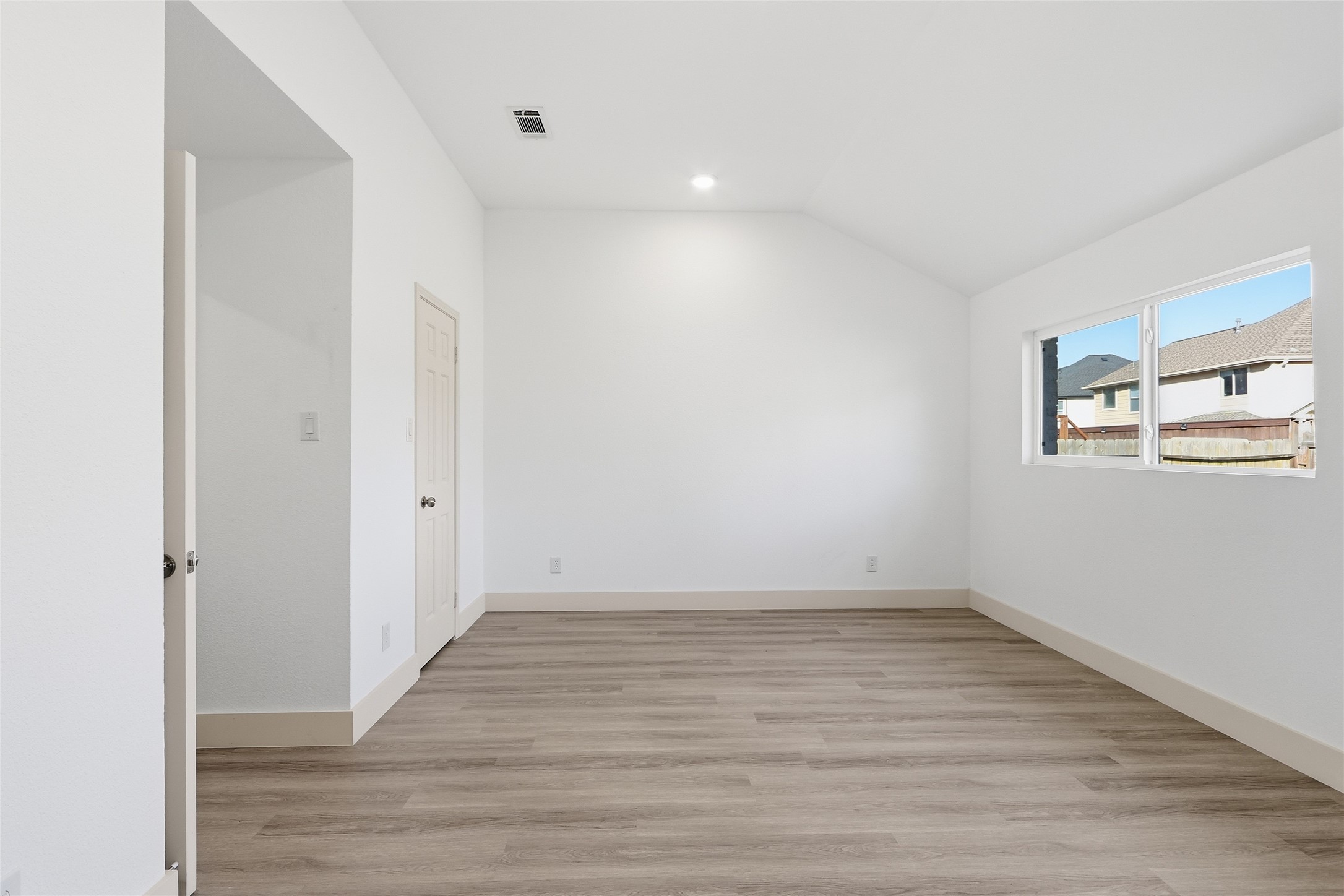 19110 Baton Pass Humble, TX 77346 - Photo 24 of 41 a view of an empty room with wooden floor and a window