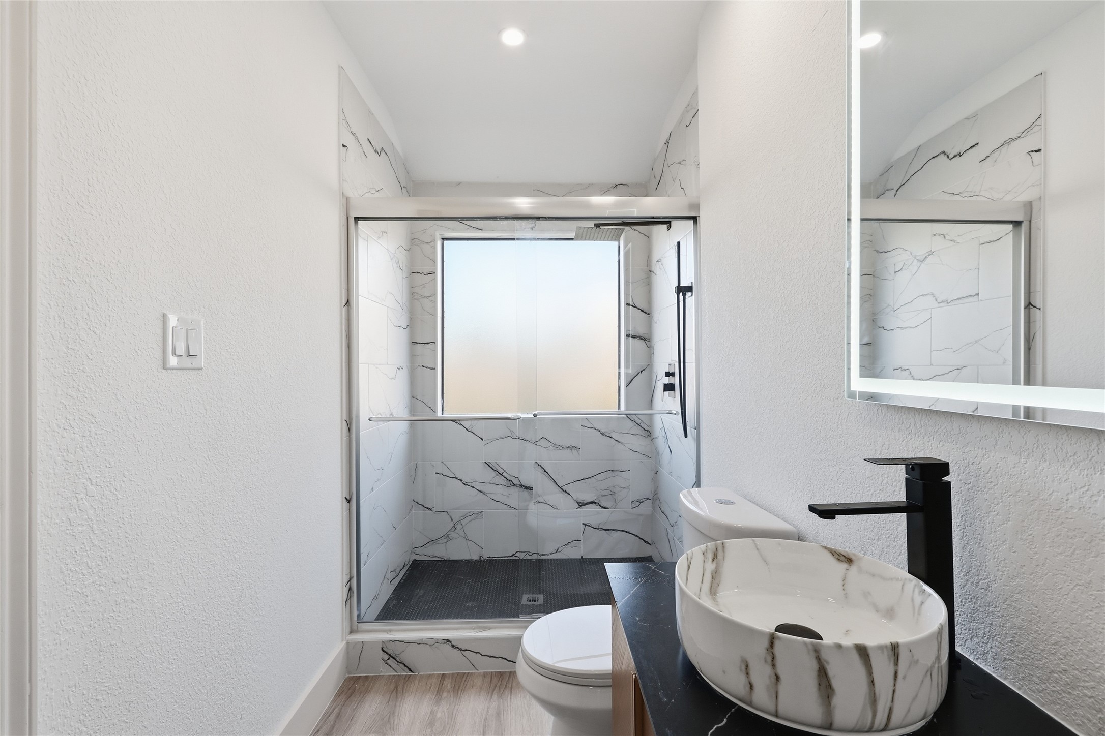 19110 Baton Pass Humble, TX 77346 - Photo 27 of 41 a bathroom with a toilet and a mirror