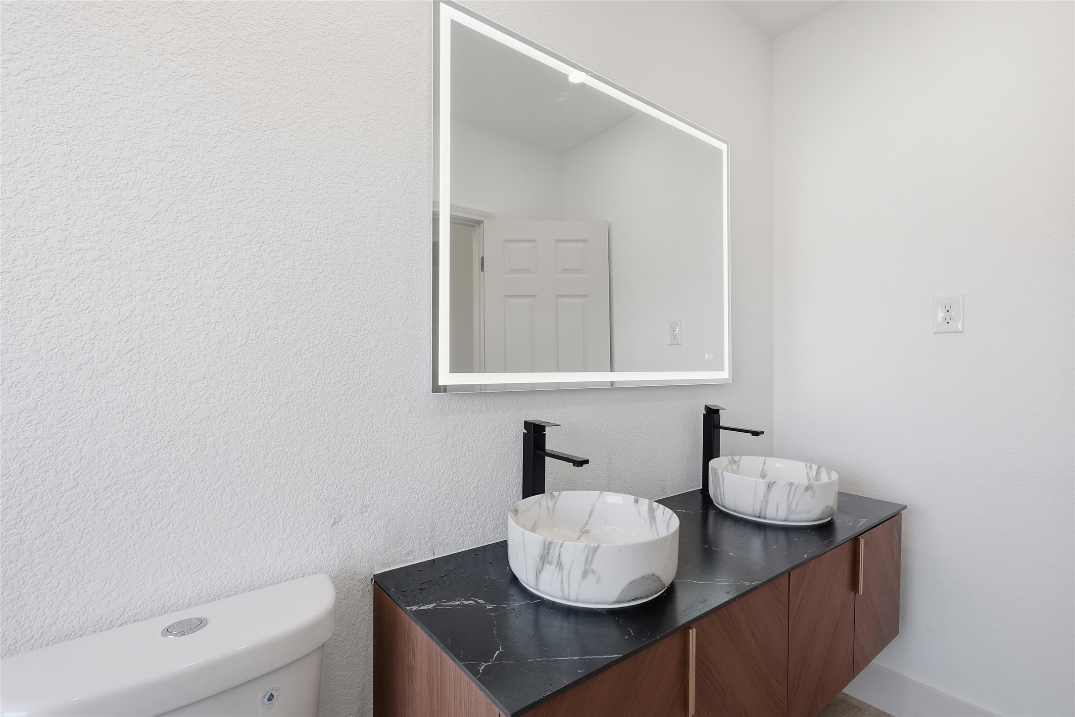 19110 Baton Pass Humble, TX 77346 - Photo 28 of 41 a bathroom with a sink a toilet and a mirror