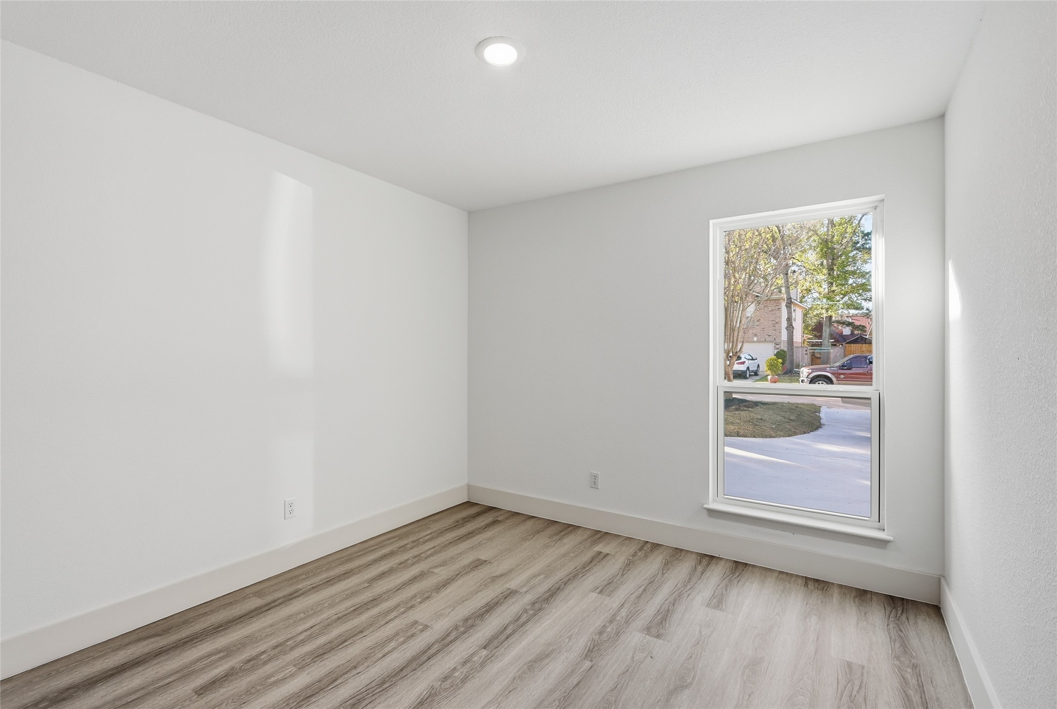 19110 Baton Pass Humble, TX 77346 - Photo 29 of 41 an empty room with wooden floor and a window