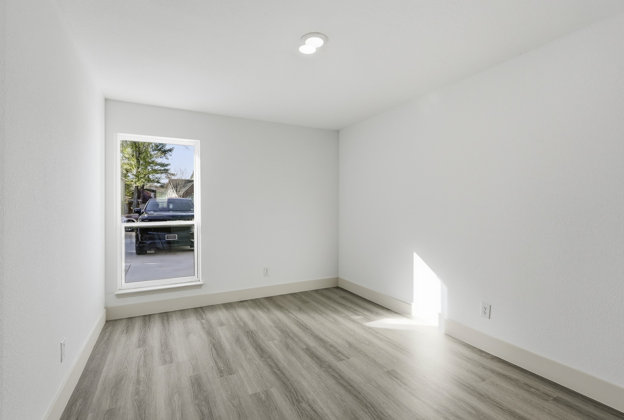 19110 Baton Pass Humble, TX 77346 - Photo 31 of 41 wooden floor in an empty room with a window