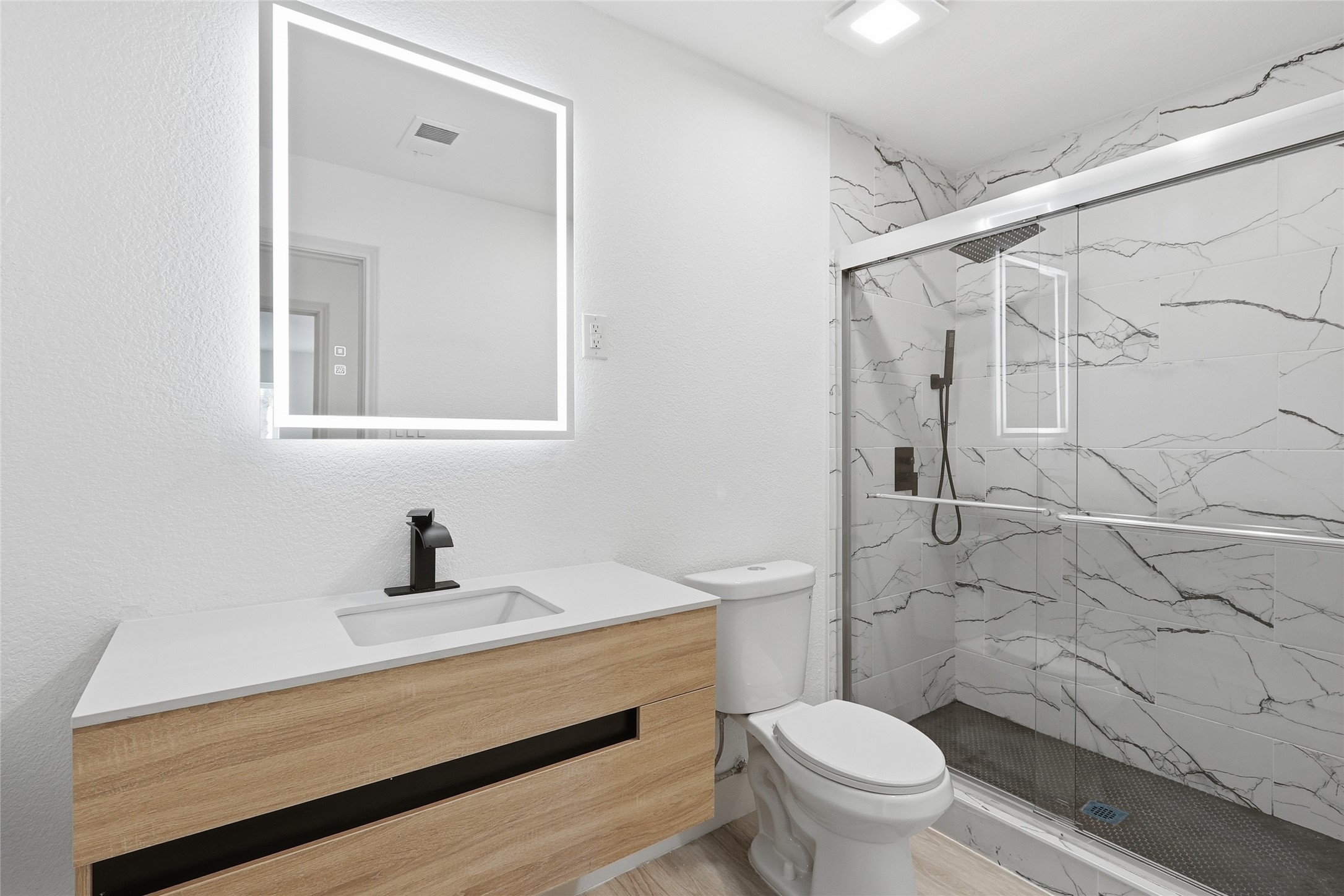 19110 Baton Pass Humble, TX 77346 - Photo 33 of 41 a bathroom with a sink a toilet and a shower