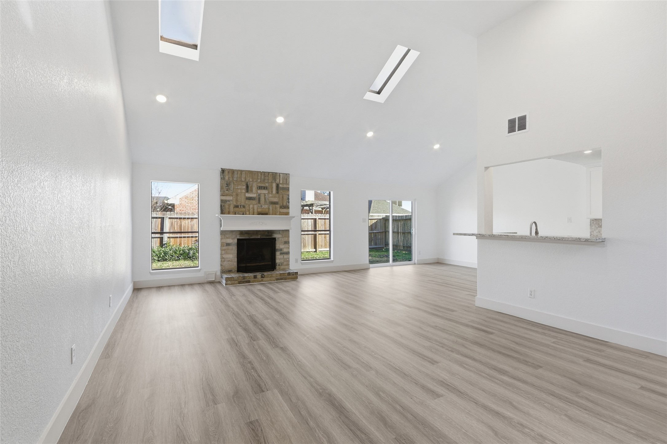 19110 Baton Pass Humble, TX 77346 - Photo 7 of 41 an empty room with wooden floor and fireplace