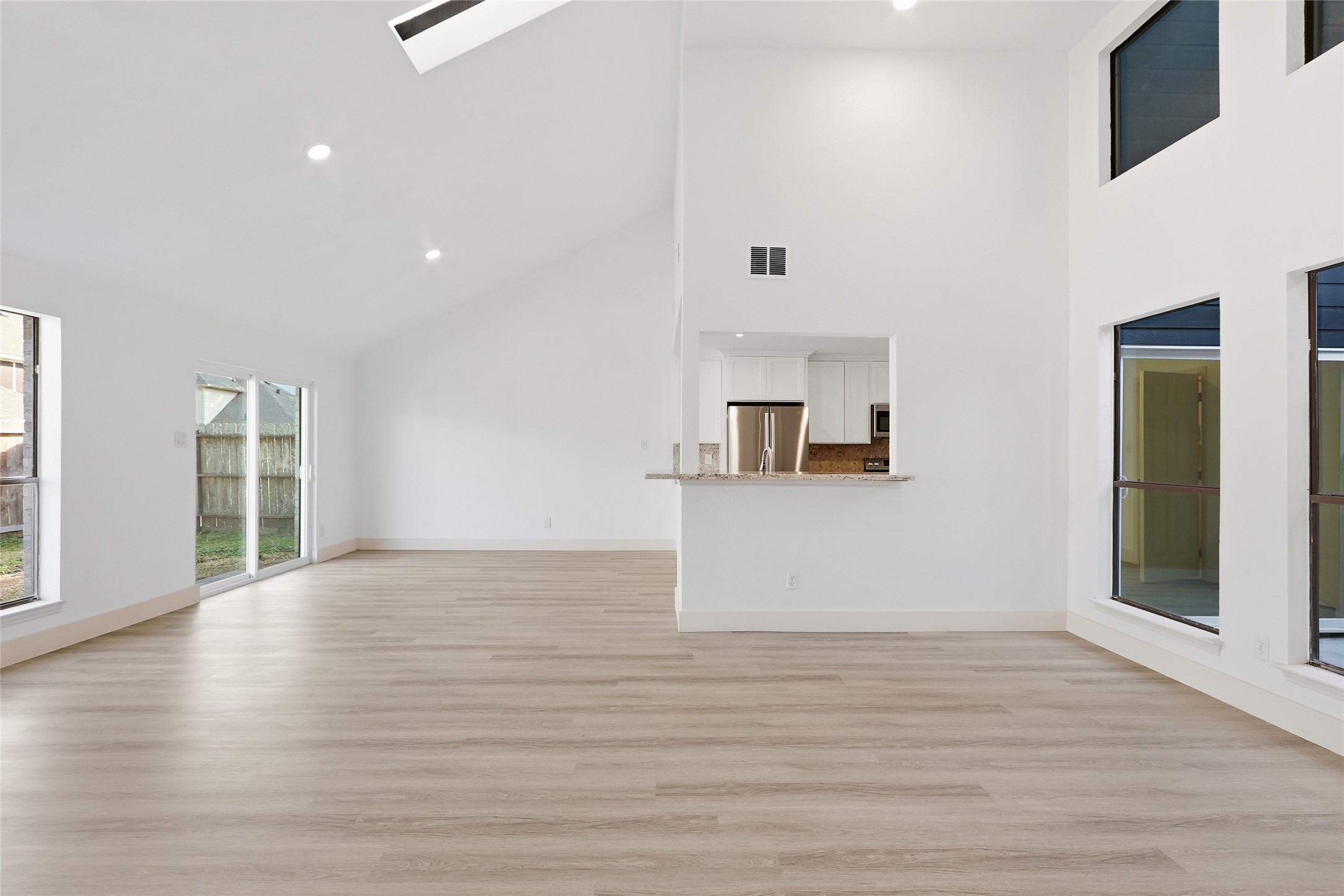 19110 Baton Pass Humble, TX 77346 - Photo 9 of 41 Kitchen, dining and living areas connect under the high vaulted ceiling