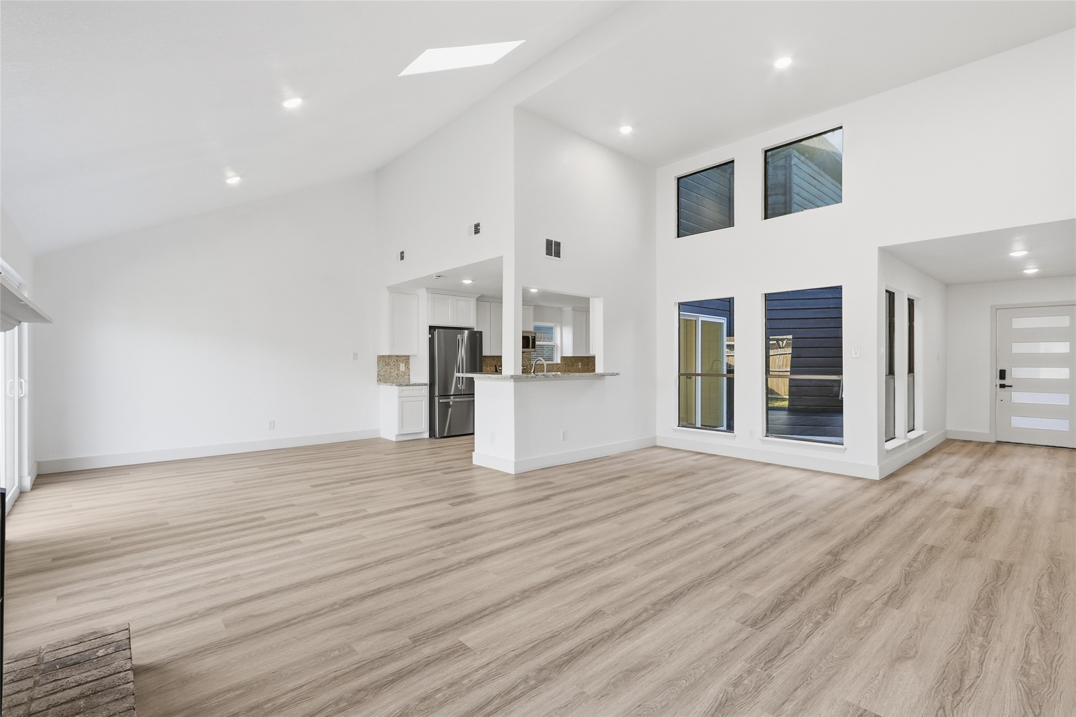 19110 Baton Pass Humble, TX 77346 - Photo 10 of 41 Kitchen, dining and living areas connect under the high vaulted ceiling, overlooking the atrium.