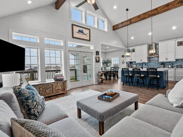 a living room with lots of furniture and kitchen view