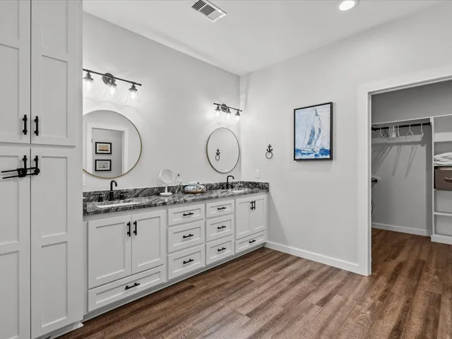 a bathroom with granite countertop a sink and a mirror