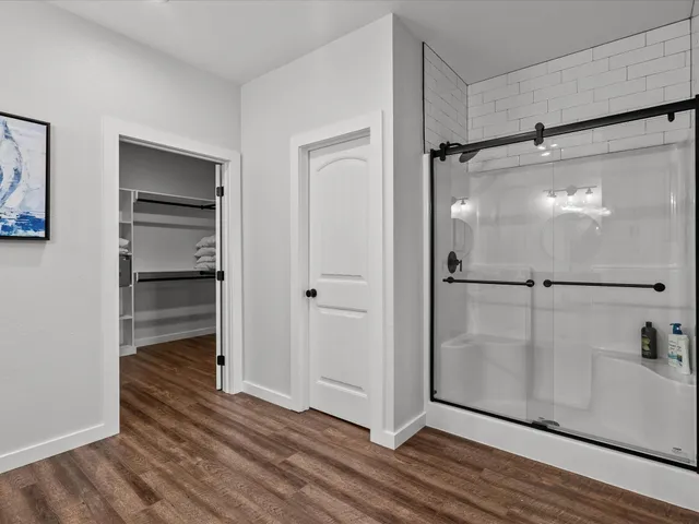 a view of a room with wooden floor