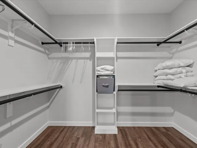 a view of walk in closet with empty racks