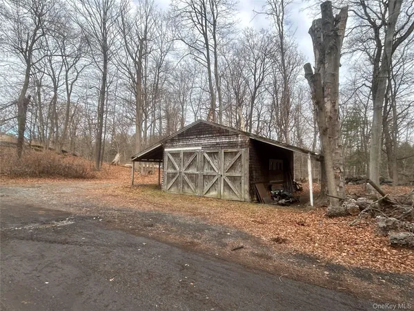 a view of a house with a yard covered with snow in the background