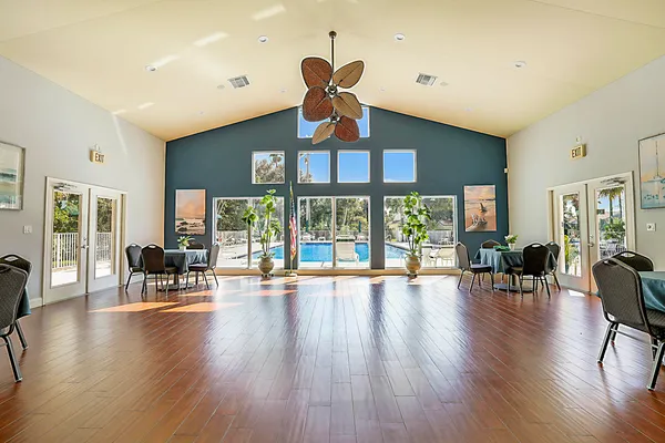 a view of a dining room with furniture a rug and wooden floor